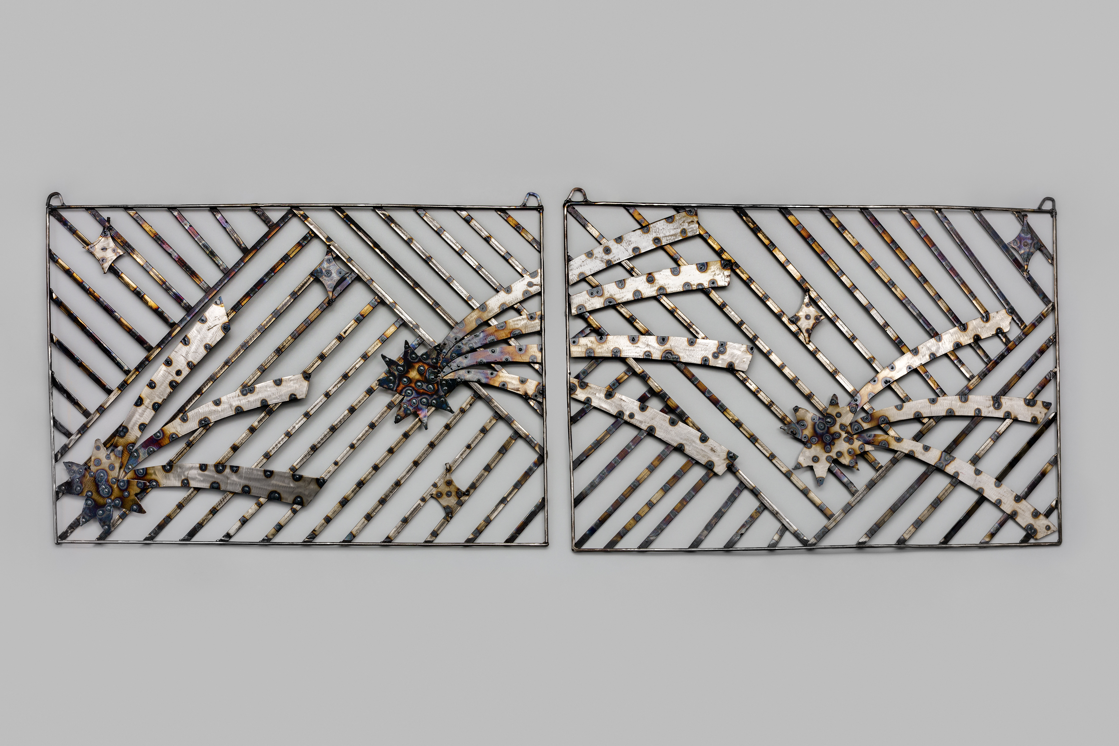 Two steel welded panels with criss-cross pattern and shooting stars