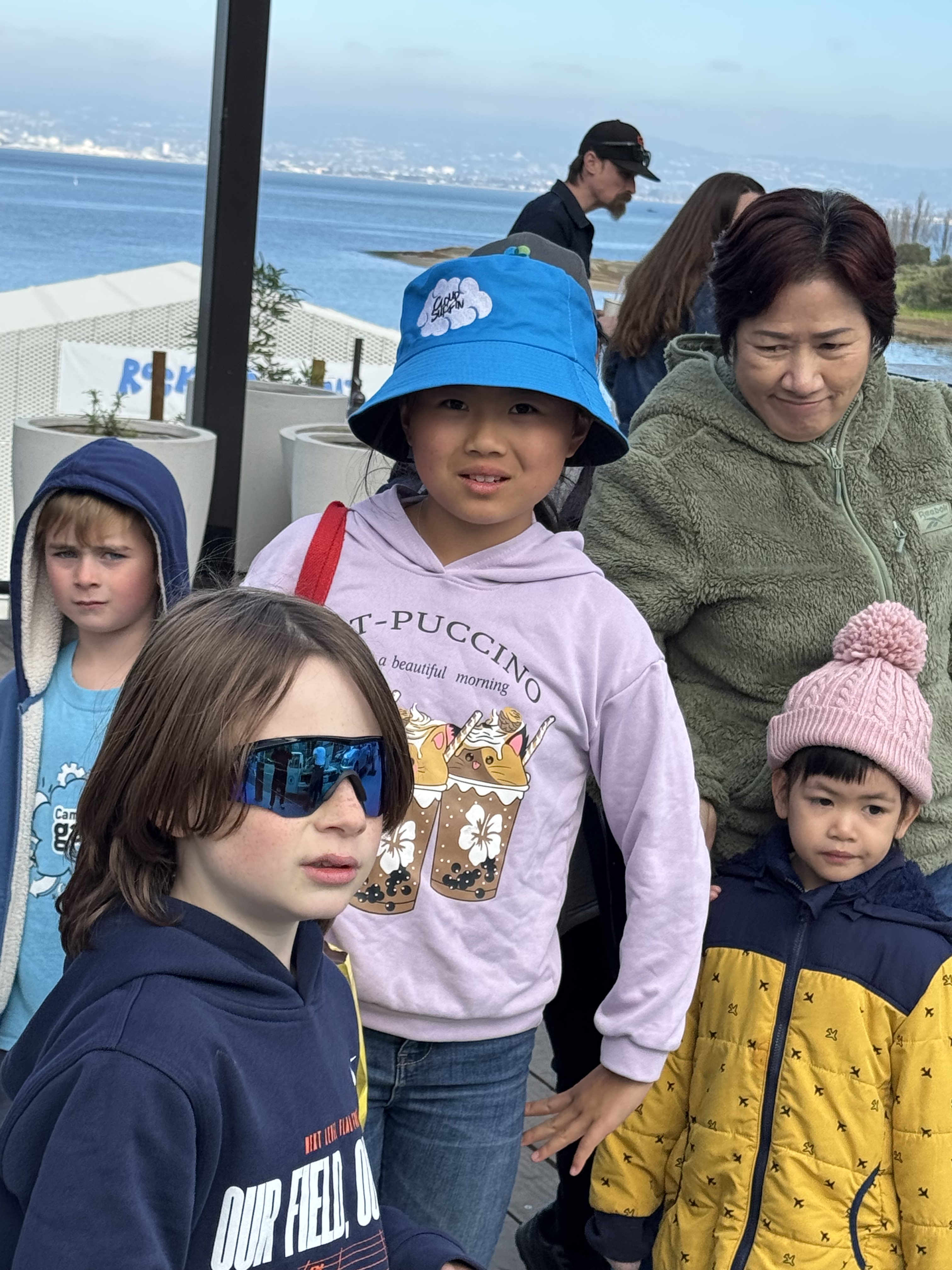 kids in a group, center child is wearing a purple DineroGeppetto shirt