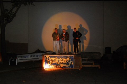 three figures standing on a stage in a spotlight